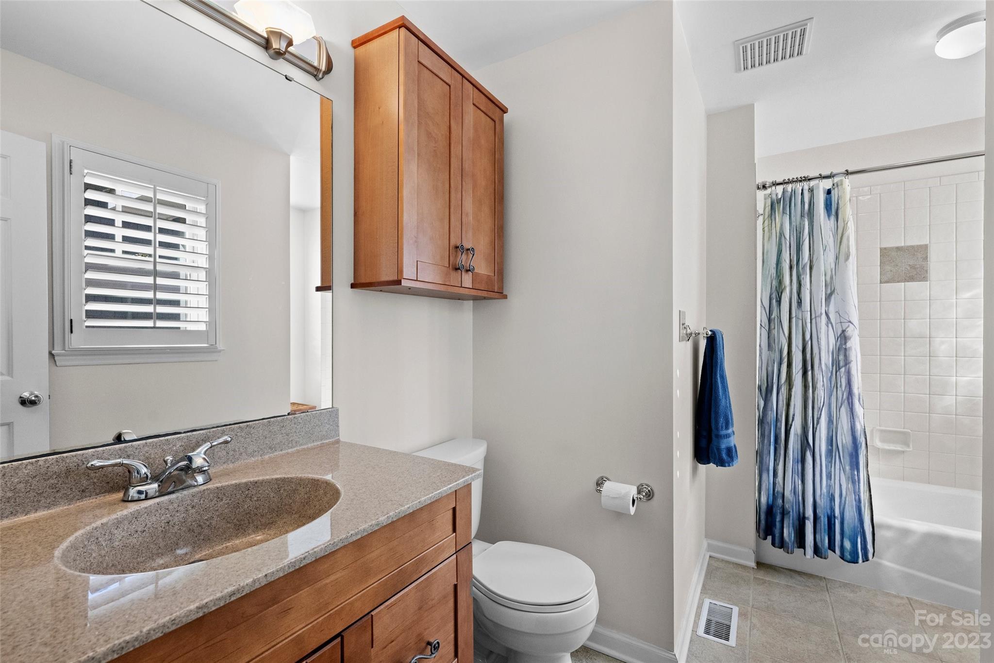 711 Romany Road Charlotte, NC 28203 - Photo 17 of 28 a bathroom with a granite countertop sink toilet and shower