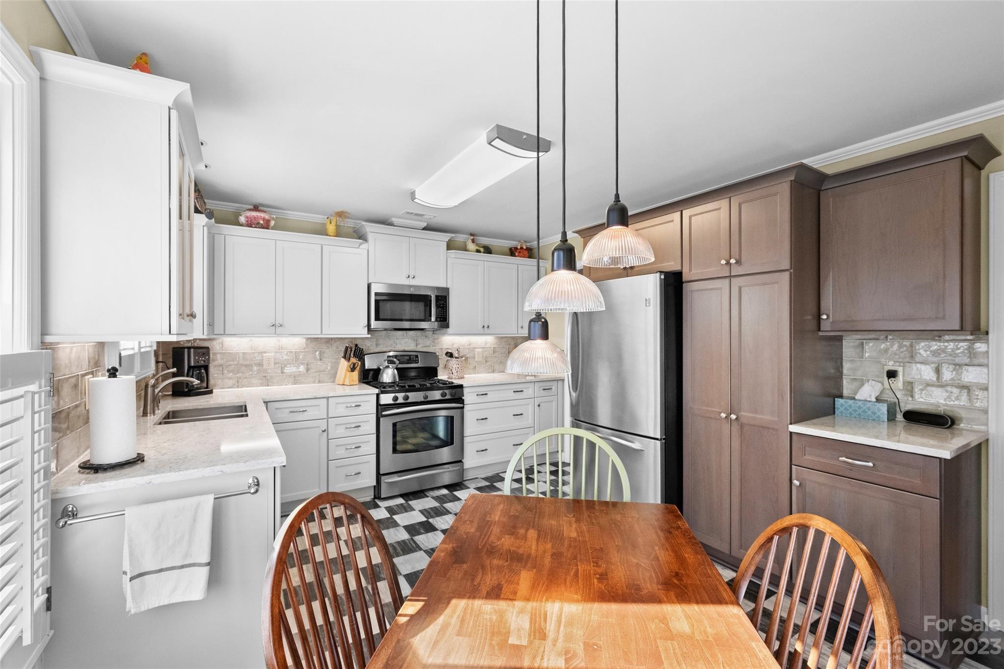 711 Romany Road Charlotte, NC 28203 - Photo 9 of 28 a kitchen with stainless steel appliances granite countertop a refrigerator a stove a sink dishwasher a oven with white cabinets and wooden floor