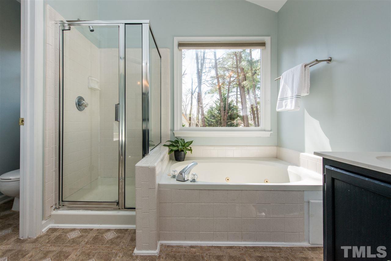 5504 Edgebury Road Raleigh, NC 27613 - Photo 17 of 25 a bathroom with a bathtub and shower