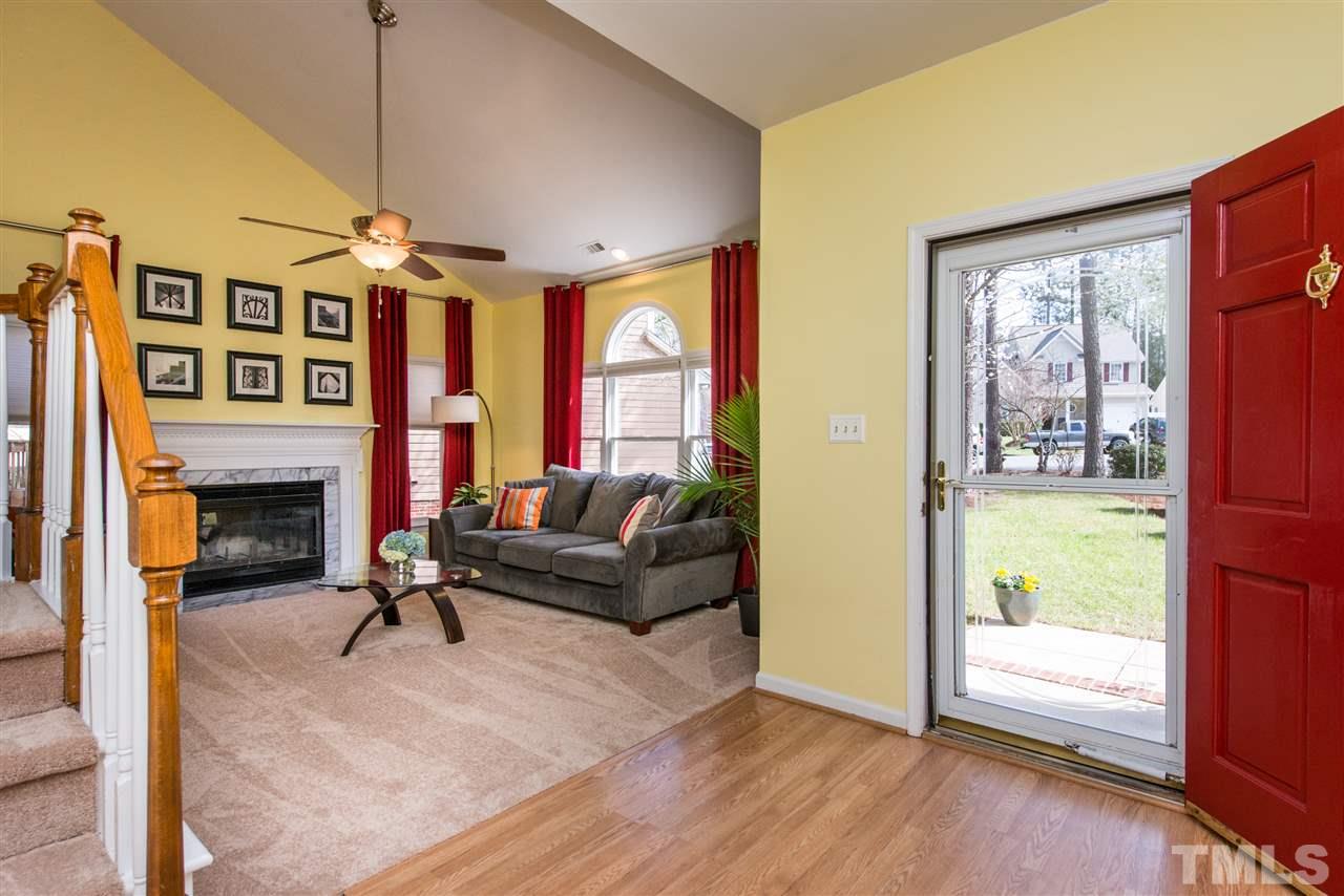 5504 Edgebury Road Raleigh, NC 27613 - Photo 3 of 25 a living room with furniture large window and a fireplace