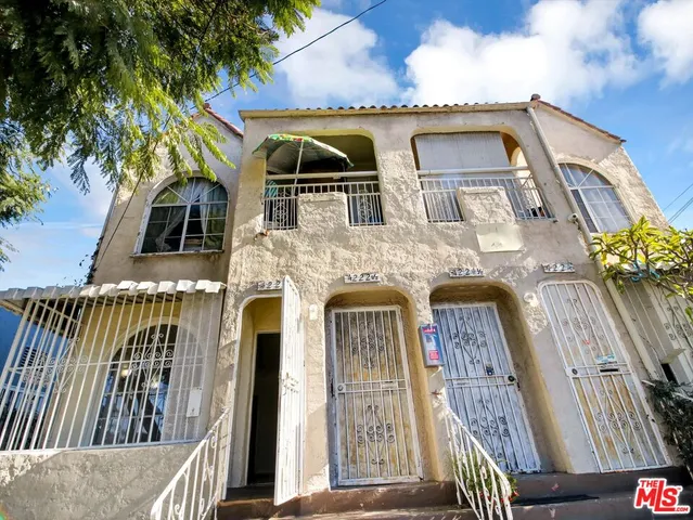 a view of a room with wooden floor and windows