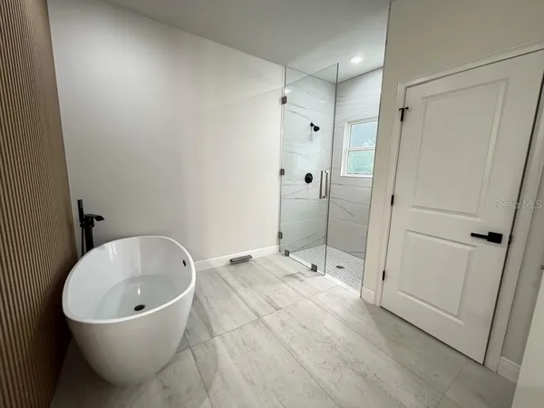 a bathroom with a bathtub and shower