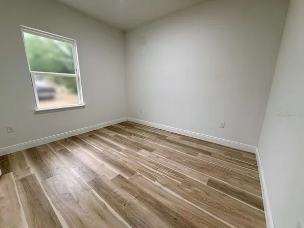 a view of room with window and hardwood floor