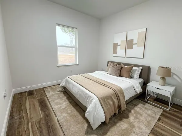 a bedroom with a bed and a window