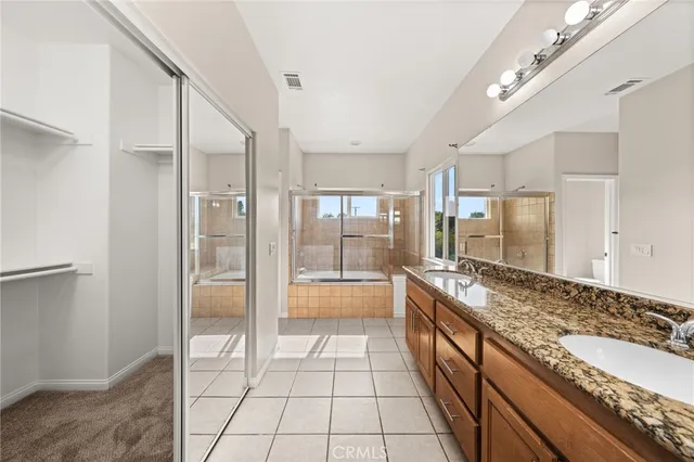 a large spacious bathroom with a granite countertop tub shower and sink