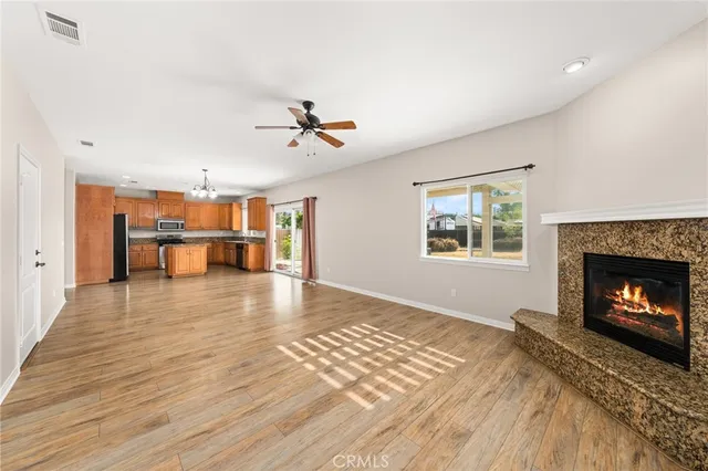 a view of a livingroom with a fireplace and window