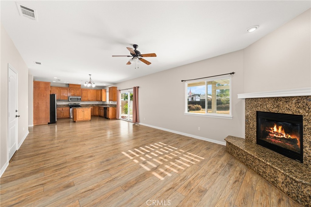 15868 Shorb Street Riverside, CA 92508 - Photo 2 of 15 a view of a livingroom with a fireplace and window