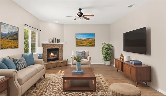 a living room with furniture a flat screen tv and a fireplace