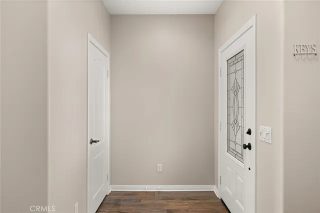 a view of an entryway with wooden floor
