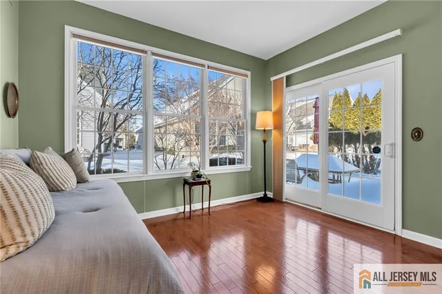 a living room with furniture and large windows