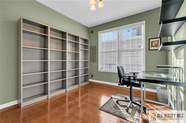 a view of a workspace with furniture and a window