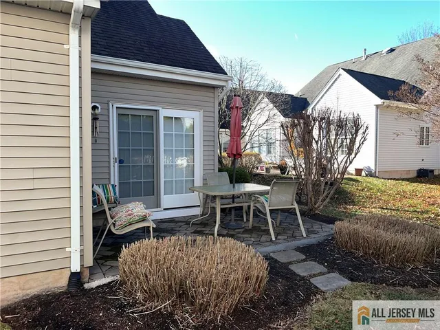 a view of a house with backyard and sitting area