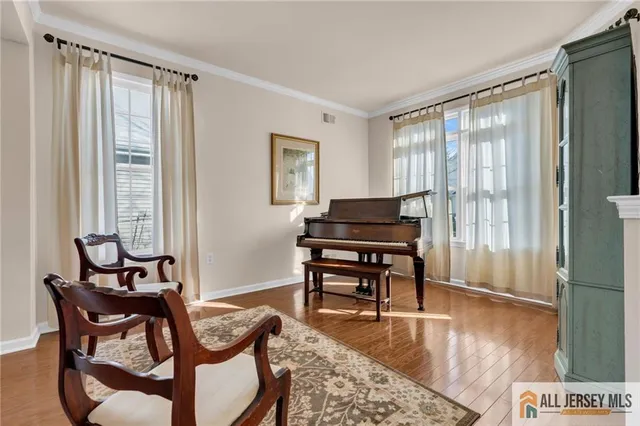 a view of a livingroom with furniture window and wooden floor