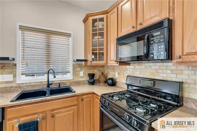 a kitchen with stainless steel appliances a stove sink and cabinets