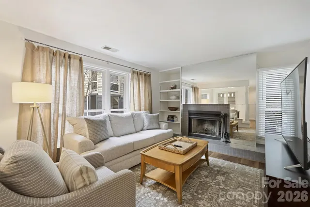 a living room with furniture a rug and a fireplace
