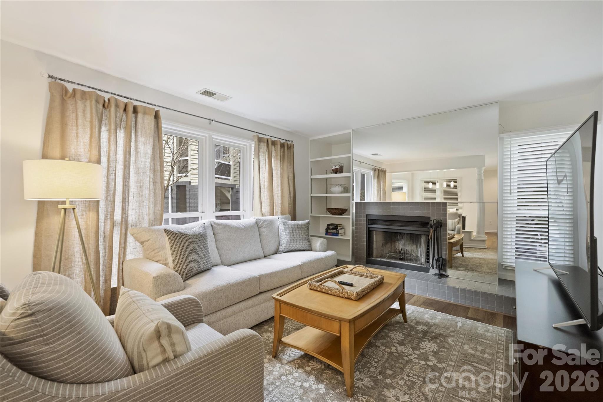 607 Queens Road Charlotte, NC 28207 - Photo 12 of 26 a living room with furniture a rug and a fireplace