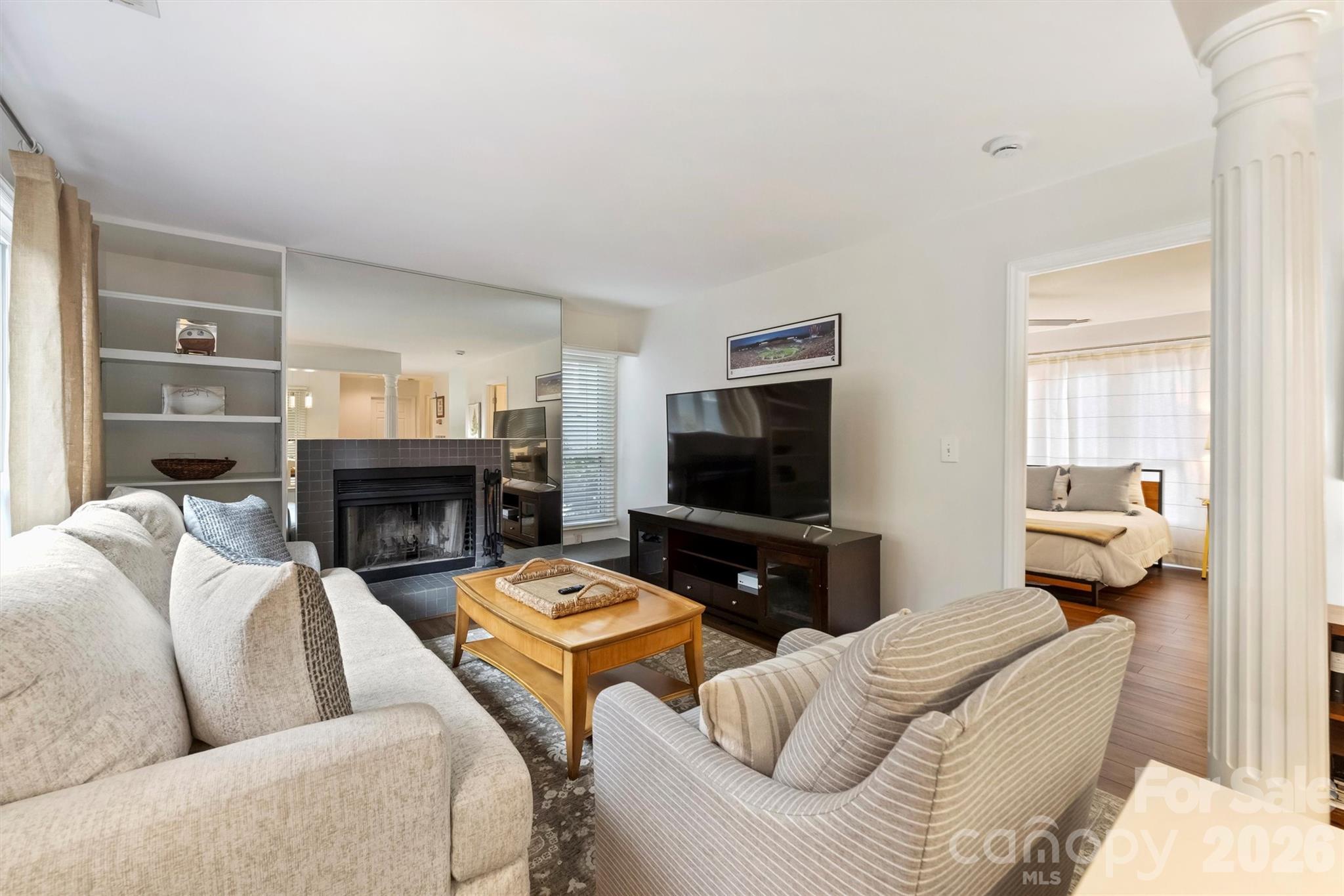607 Queens Road Charlotte, NC 28207 - Photo 13 of 26 a living room with furniture a fireplace and a flat screen tv