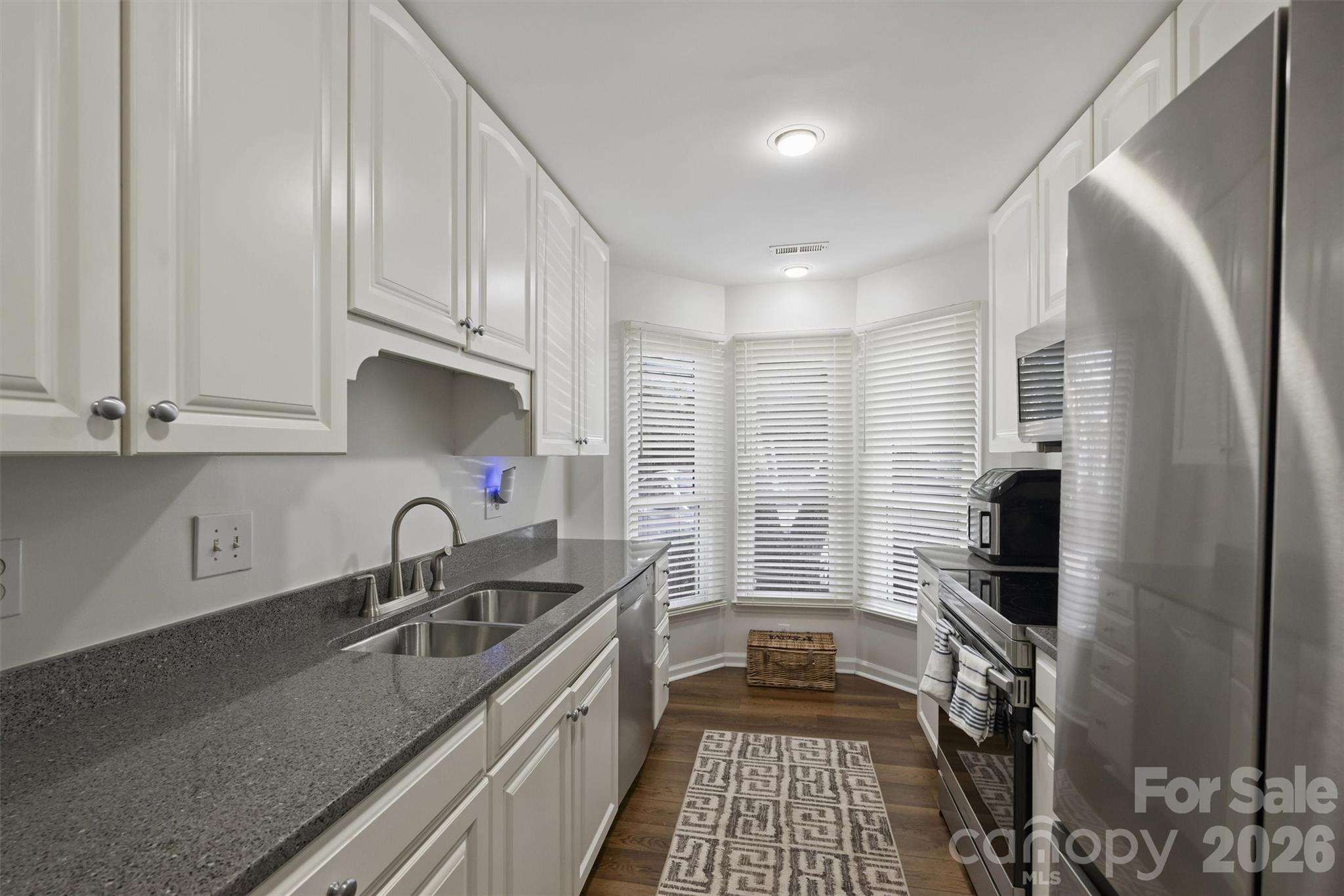 607 Queens Road Charlotte, NC 28207 - Photo 17 of 26 a kitchen with stainless steel appliances a sink stove and cabinets