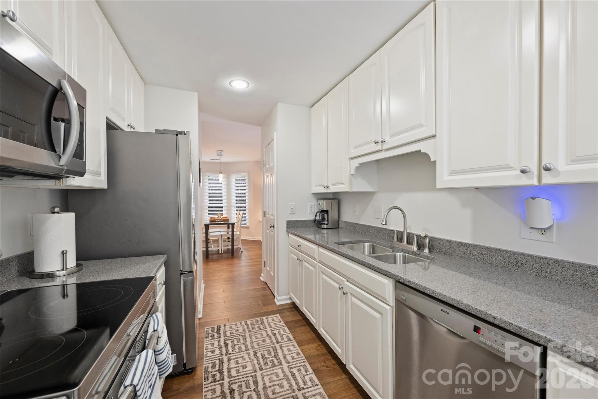 607 Queens Road Charlotte, NC 28207 - Photo 19 of 26 a kitchen with stainless steel appliances granite countertop a sink stove and cabinets
