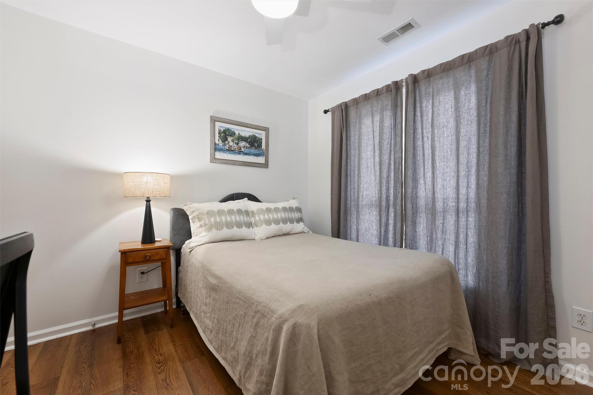 607 Queens Road Charlotte, NC 28207 - Photo 25 of 26 a bedroom with a bed and a night stand