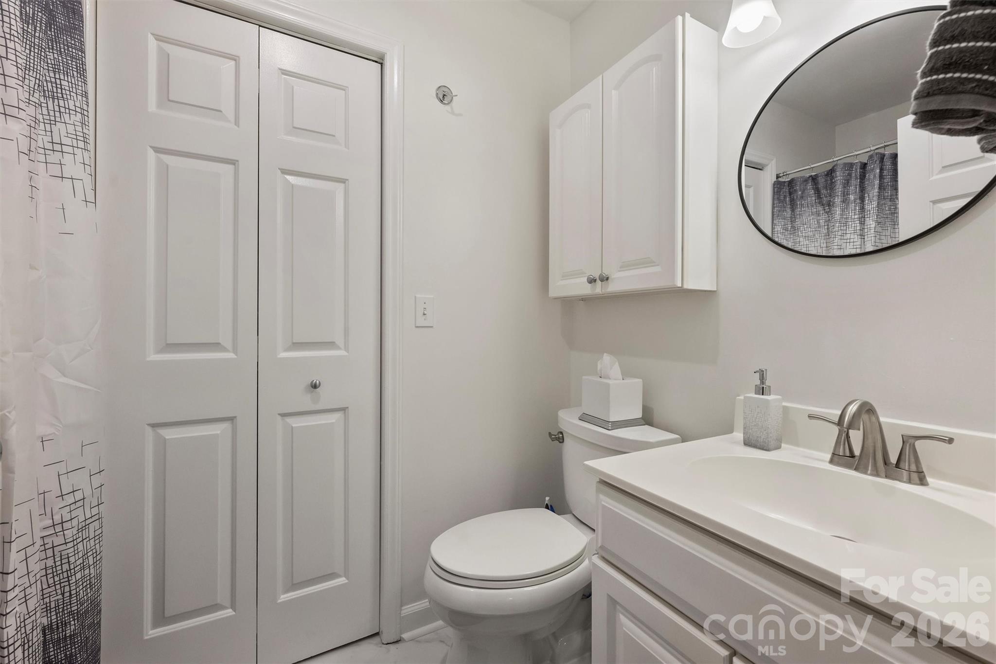 607 Queens Road Charlotte, NC 28207 - Photo 26 of 26 a bathroom with a toilet a sink and mirror