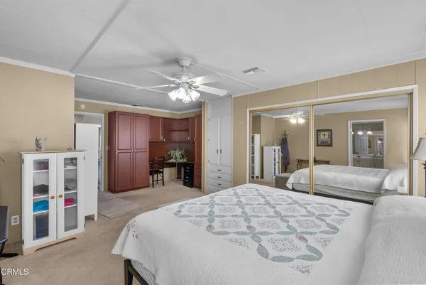 a bedroom with a large bed and a chandelier
