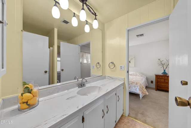 a bathroom with a double vanity sink mirror and toilet