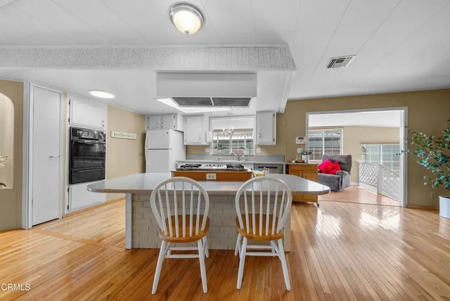 a dining room with a wooden table and chairs
