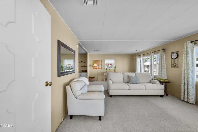 a living room with furniture white walls and white walls