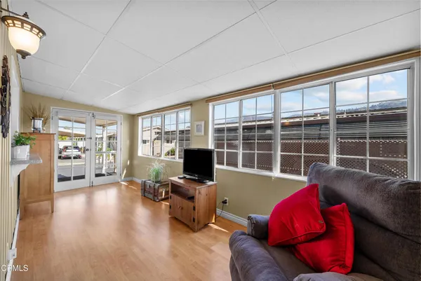a living room with furniture window and a flat screen tv