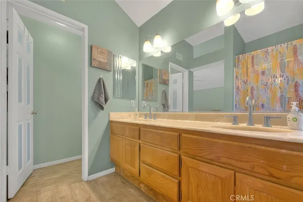 a bathroom with a tub sink and mirror