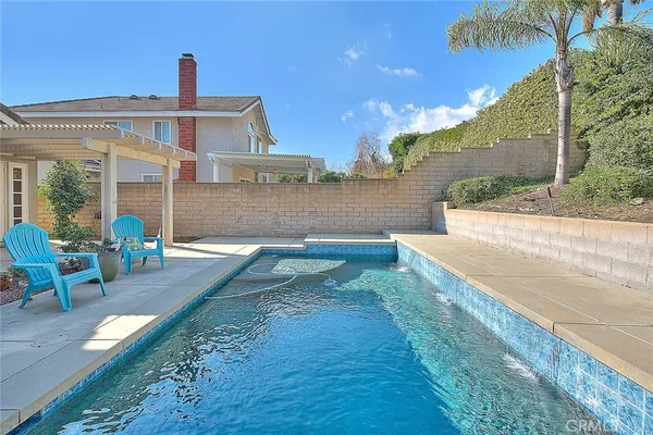 a view of a house with table and chairs in patio