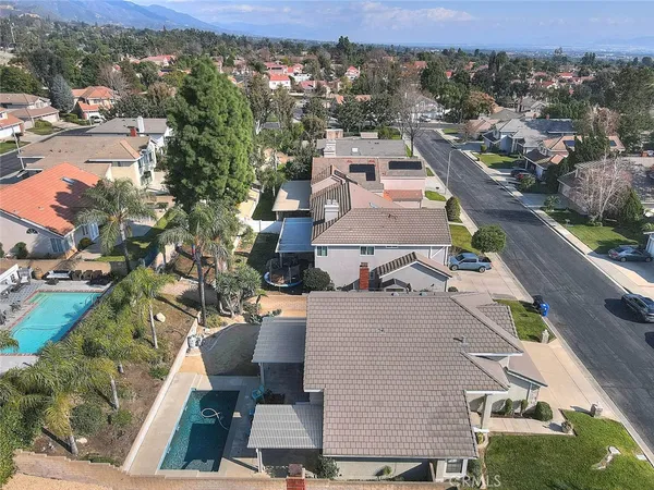 an aerial view of residential houses with outdoor space and city view