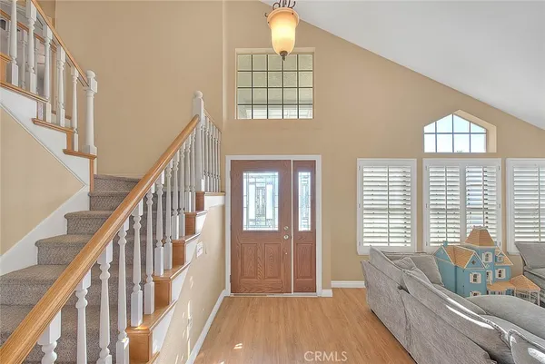 a view of an entryway wooden floor and windows