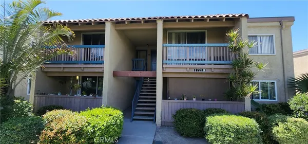 a front view of a house with lots of flowers