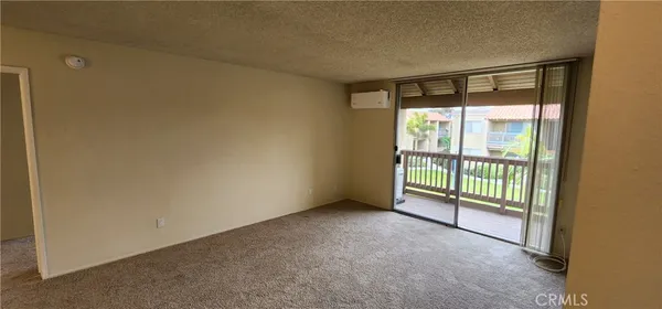 a view of an empty room with sliding glass door
