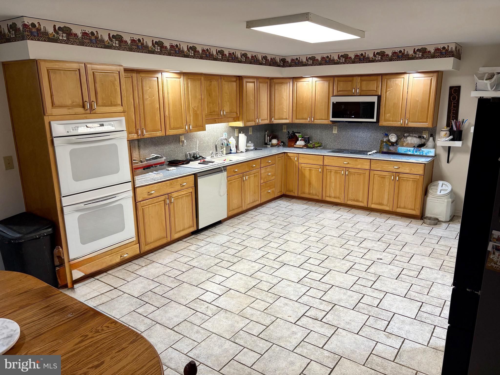 48 Sandy Lane Millville, NJ 08332 - Photo 3 of 6 a kitchen with stainless steel appliances a sink and a refrigerator