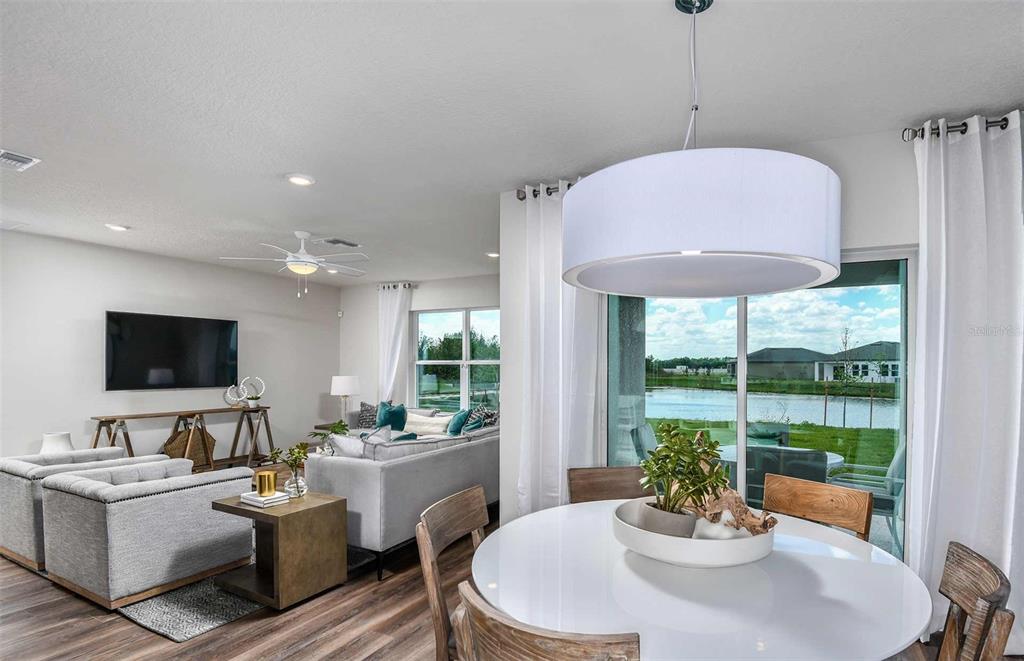 12816 Blue Reflection Avenue Parrish, FL 34219 - Photo 5 of 12 a view of a dining room with furniture window and outside view