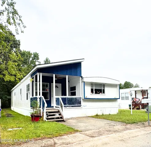 a view of a house with a yard and sitting area