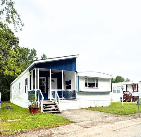 a view of a house with a yard and sitting area