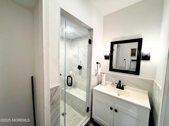 a bathroom with a tub sink and mirror
