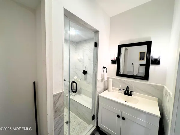 a bathroom with a tub sink and mirror