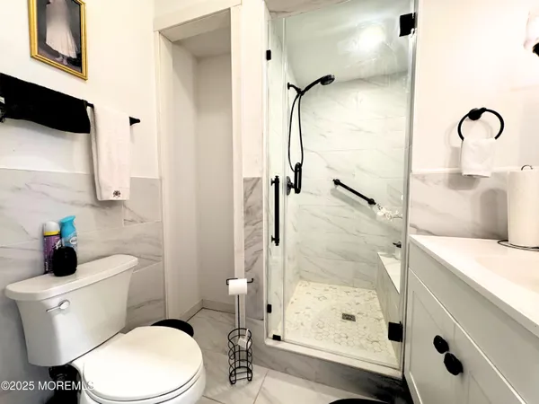 a white toilet sitting next to a bathroom sink