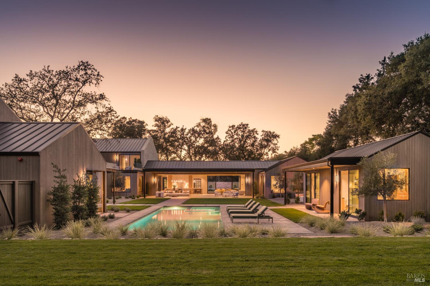 a front view of a house with swimming pool having outdoor seating