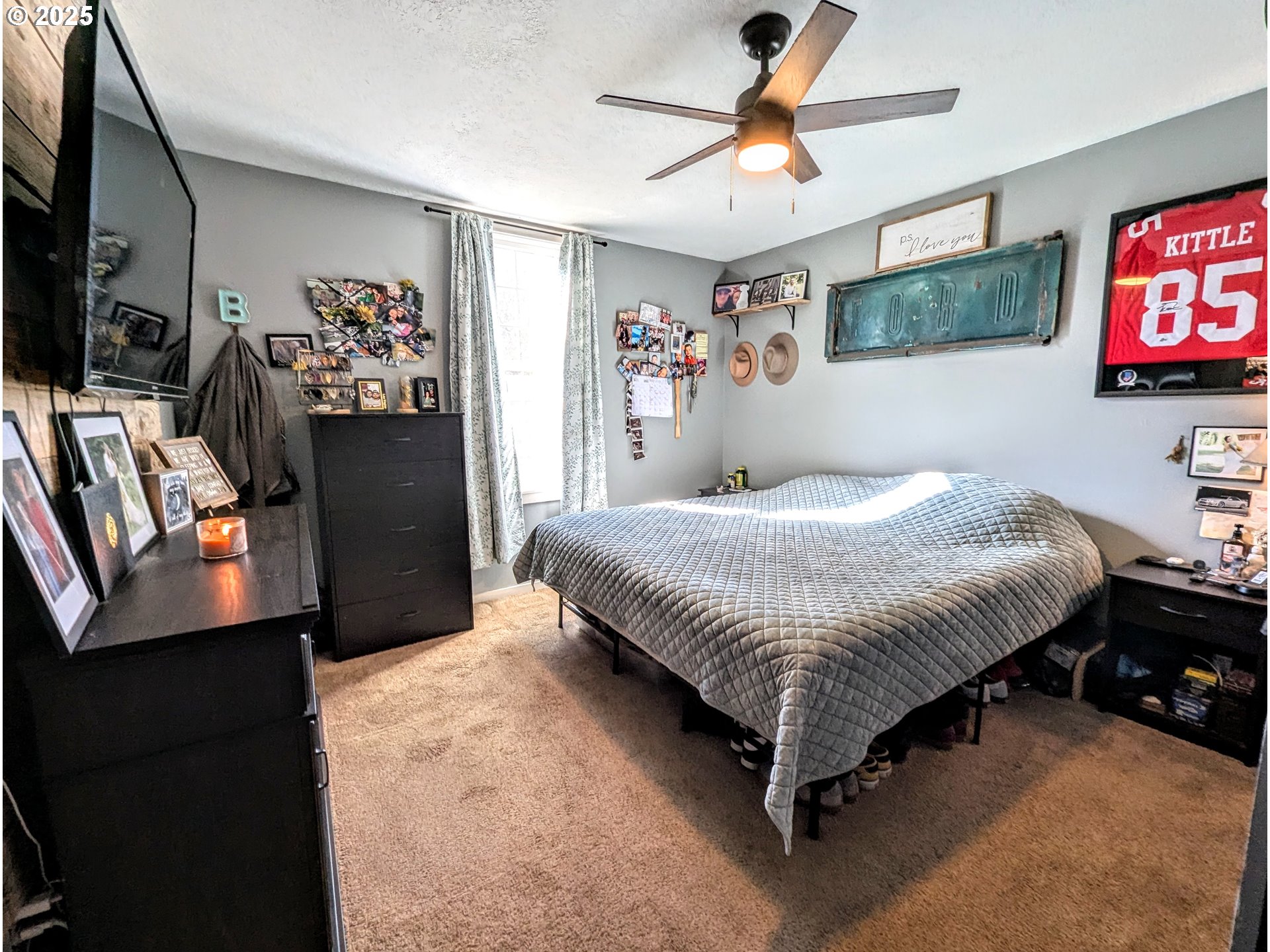 362 South 4th Street Union, OR 97883 - Photo 9 of 19 a bedroom with a bed a dresser and a flat screen tv