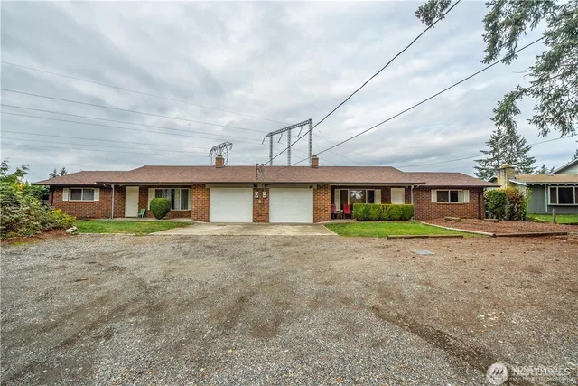a front view of brick house with a yard