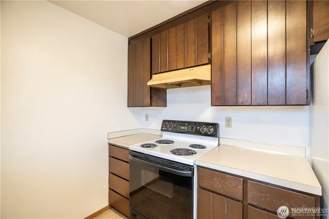 a kitchen with a sink cabinets and appliances