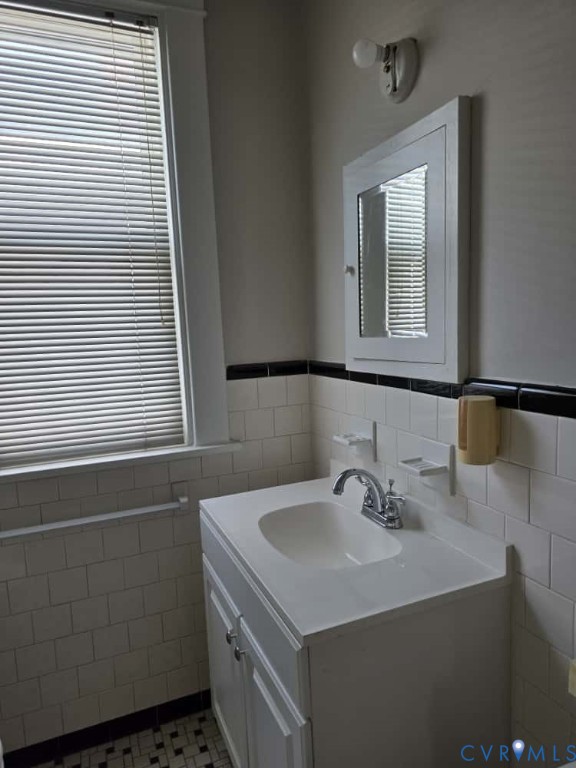 2702 Seminary Avenue Richmond, VA 23220 - Photo 18 of 29 Half bath with tile walls, vanity, a wainscoted wa