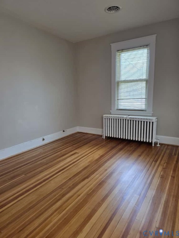 2702 Seminary Avenue Richmond, VA 23220 - Photo 20 of 29 Unfurnished room featuring radiator and light wood