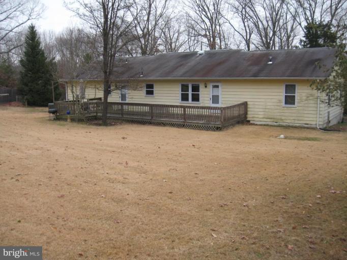 2435 Hallowing Point Road Prince Frederick, MD 20678 - Photo 2 of 3 a front view of house with yard and trees around